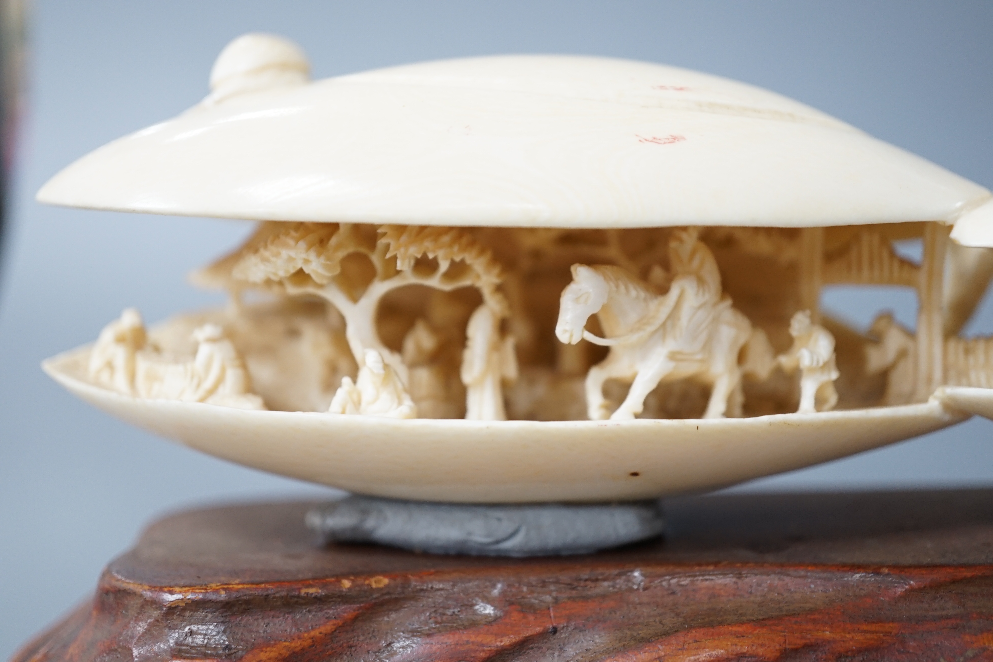 A large Japanese ivory model of the clam’s dream, Meiji period, wood stand. 18cm long